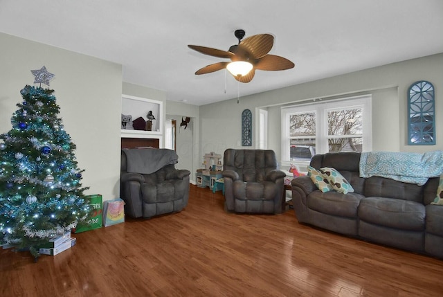 living room featuring wood-type flooring and ceiling fan