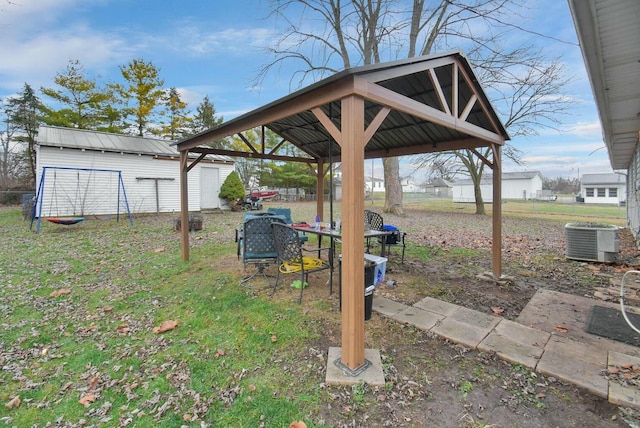 view of yard with a gazebo, a storage unit, and central AC