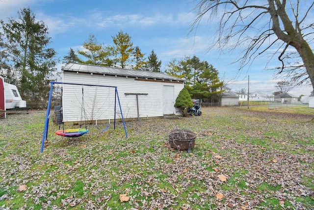 exterior space with a storage shed and an outdoor fire pit