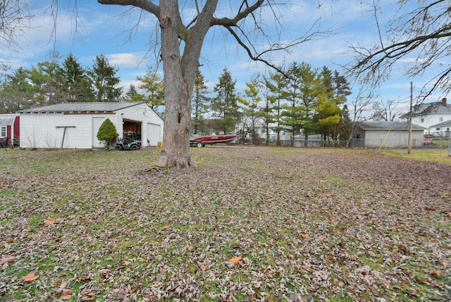 view of yard featuring an outbuilding and a garage