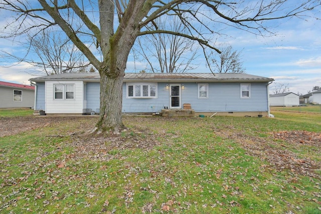 rear view of property featuring a yard