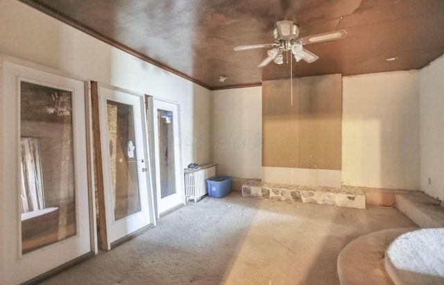 carpeted spare room with radiator, french doors, and ceiling fan