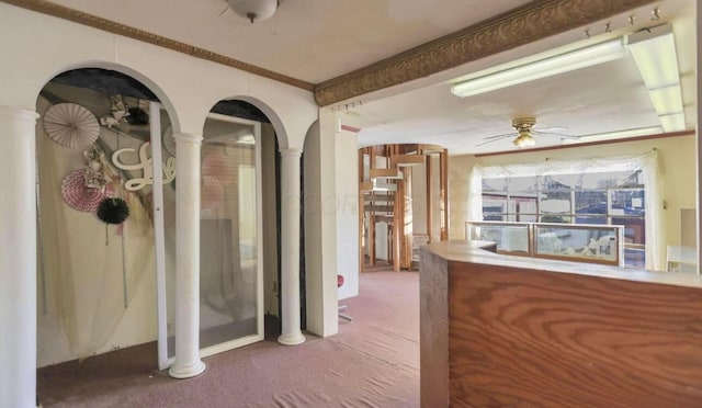 corridor featuring crown molding, carpet floors, and ornate columns