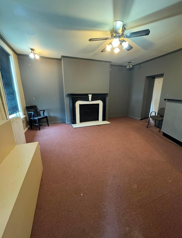 unfurnished living room featuring ornamental molding, carpet, and ceiling fan