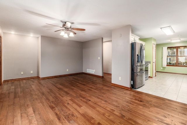 unfurnished living room with light hardwood / wood-style flooring and ceiling fan