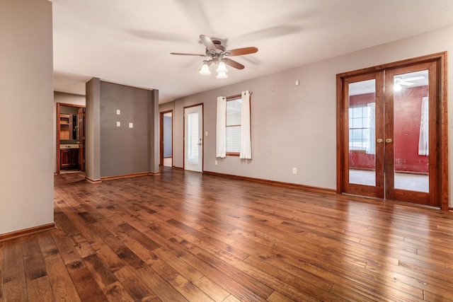 unfurnished room featuring dark wood-type flooring, ceiling fan, and french doors