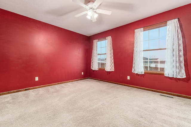 unfurnished room with carpet flooring and ceiling fan