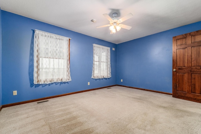 carpeted empty room with ceiling fan