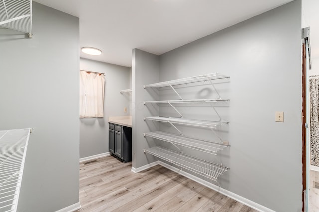 walk in closet featuring light hardwood / wood-style flooring