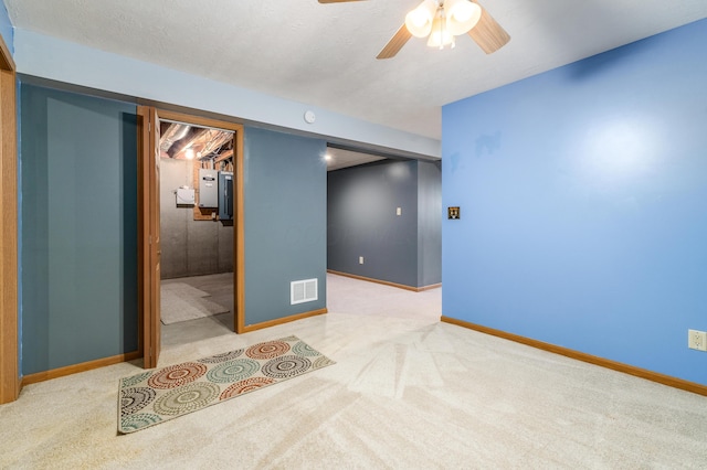 basement with carpet flooring and ceiling fan