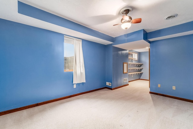 carpeted spare room with ceiling fan