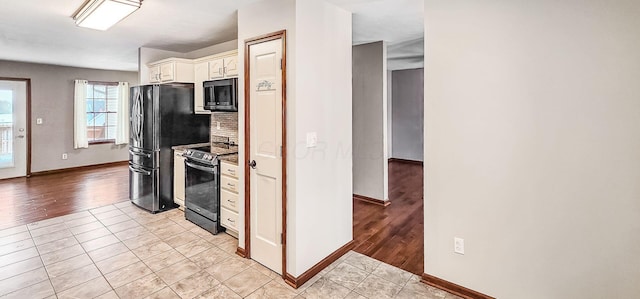 kitchen featuring white cabinetry, appliances with stainless steel finishes, and light tile patterned flooring