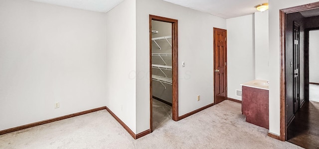 hall with light colored carpet