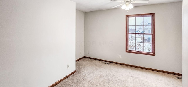 carpeted spare room featuring ceiling fan