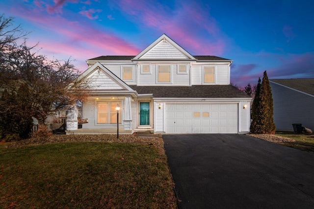 view of front of property with a yard and a garage