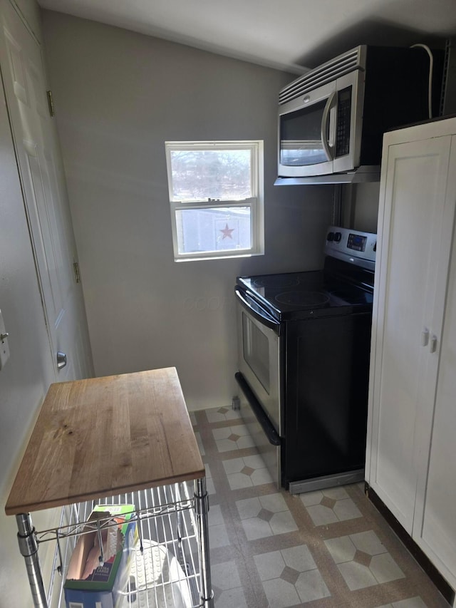 kitchen with white cabinetry and stainless steel appliances