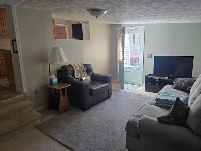 carpeted living room with a textured ceiling