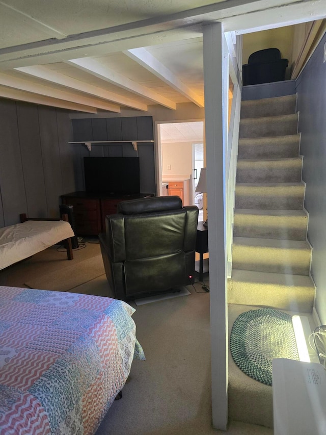 carpeted bedroom with beam ceiling