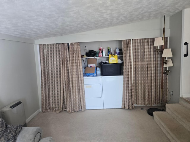 laundry area with washing machine and clothes dryer, carpet, and a textured ceiling