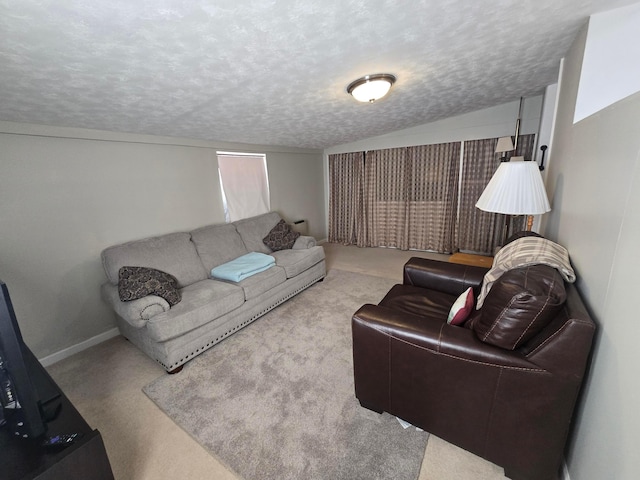 living room featuring light colored carpet and a textured ceiling