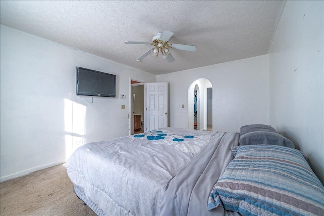 bedroom with carpet, a textured ceiling, and ceiling fan