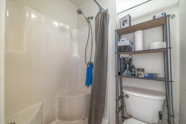 bathroom with toilet and curtained shower