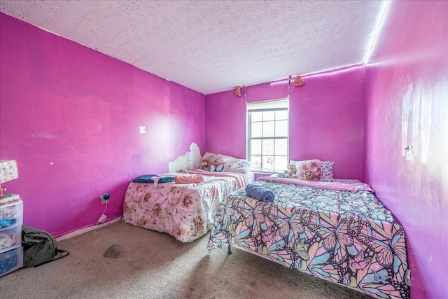 bedroom with a textured ceiling and carpet