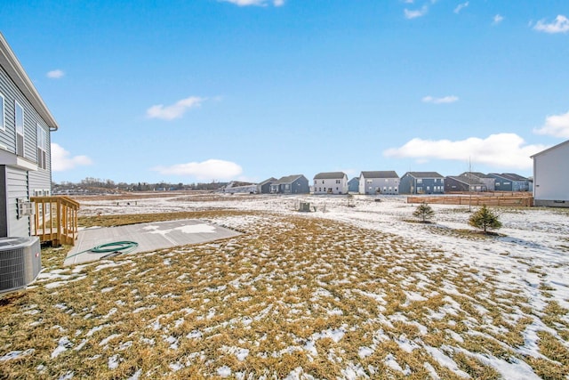 yard layered in snow with central air condition unit