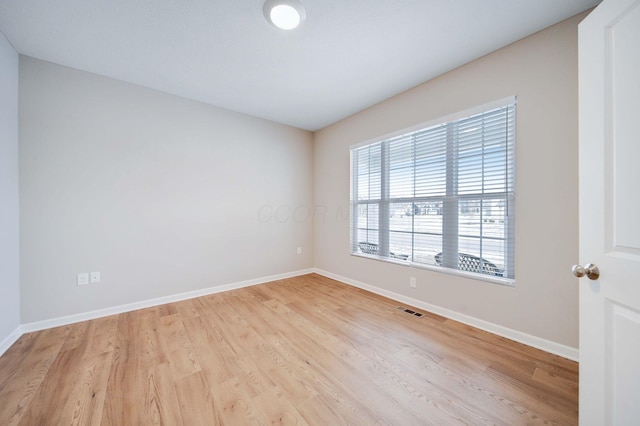 unfurnished room with light hardwood / wood-style flooring