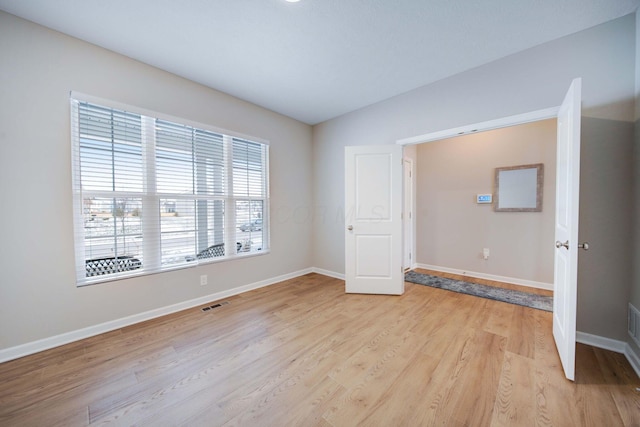 unfurnished bedroom with light wood-type flooring