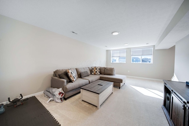 carpeted living room with a textured ceiling