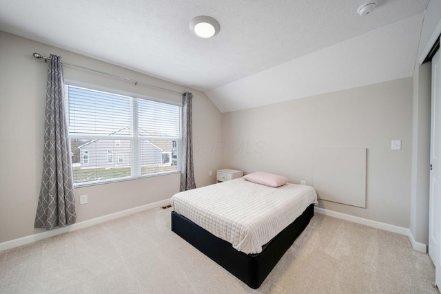 bedroom with carpet flooring and vaulted ceiling