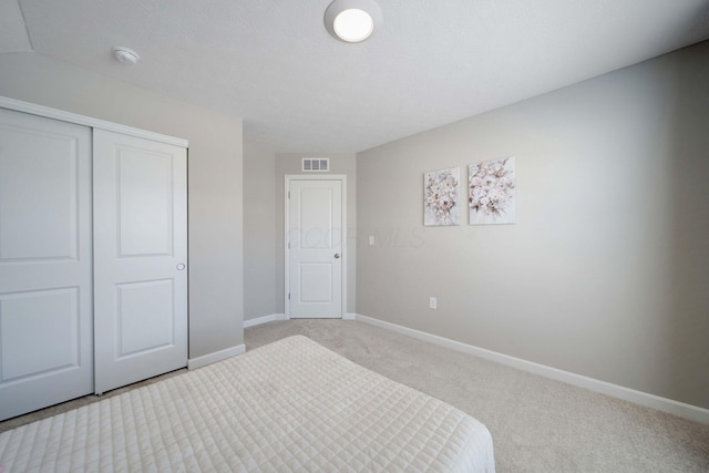 carpeted bedroom featuring a closet