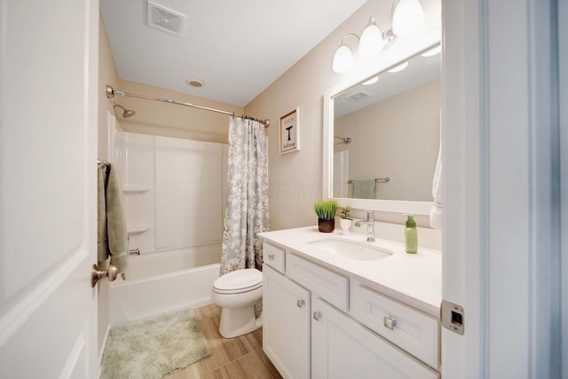 full bathroom featuring toilet, a textured ceiling, vanity, shower / bath combo, and hardwood / wood-style flooring