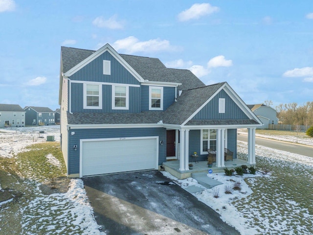 view of front facade featuring a garage and covered porch