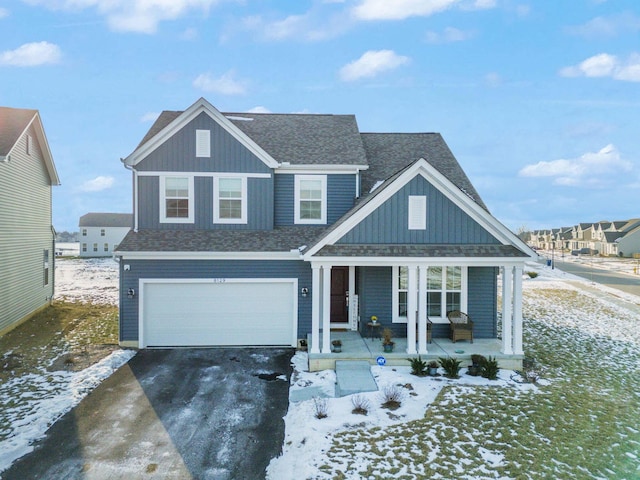 view of front of property featuring a porch and a garage