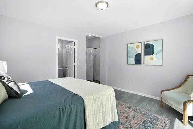 bedroom featuring ensuite bathroom, hardwood / wood-style floors, and a closet