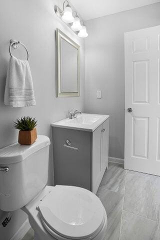 bathroom featuring vanity and toilet