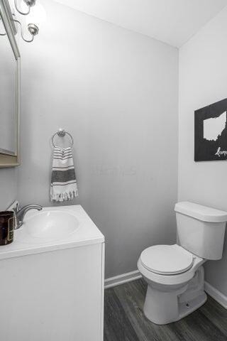 bathroom featuring vanity, hardwood / wood-style floors, and toilet