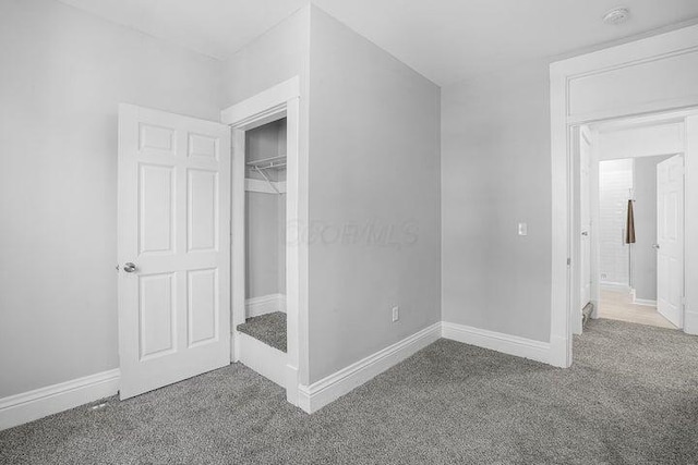 unfurnished bedroom with carpet floors and a closet