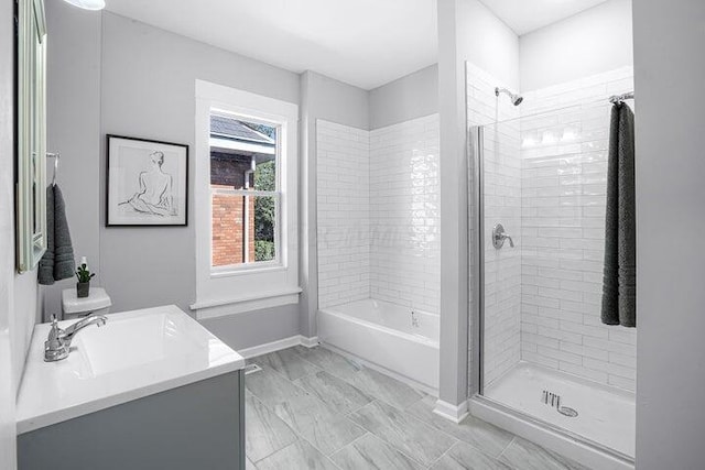 bathroom with tiled shower and vanity