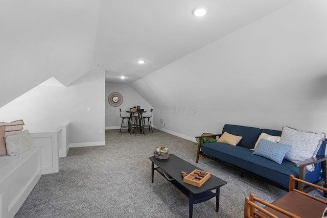 carpeted living room featuring lofted ceiling