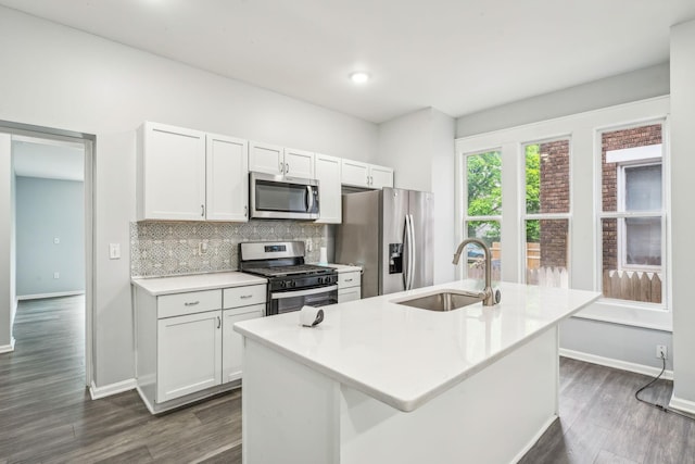 392 Morrison Ave, Columbus, OH 43205 - kitchen with stainless steel appliances, a sink, backsplash, and dark wood-style flooring