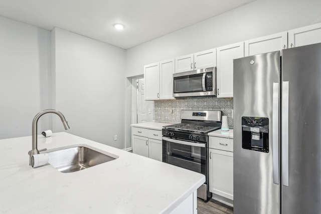 392 Morrison Ave, Columbus, OH 43205 - kitchen featuring stainless steel appliances, a sink, light countertops, backsplash, and white cabinetry