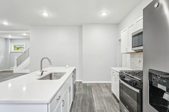 392 Morrison Ave, Columbus, OH 43205 - kitchen with stainless steel appliances, a sink, dark wood finished floors, tasteful backsplash, and baseboards