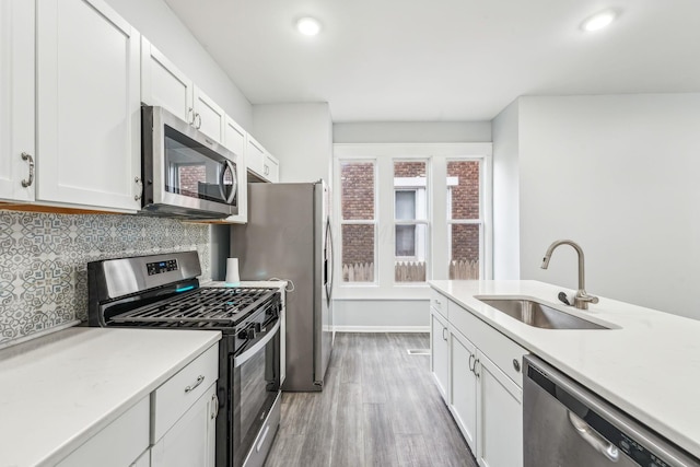 392 Morrison Ave, Columbus, OH 43205 - kitchen featuring stainless steel appliances, a sink, light wood-style floors, white cabinets, and recessed lighting