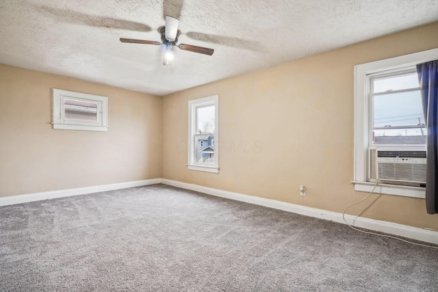 carpeted empty room with ceiling fan, cooling unit, and a textured ceiling