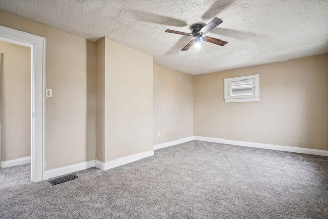 unfurnished room featuring ceiling fan, a textured ceiling, and carpet flooring