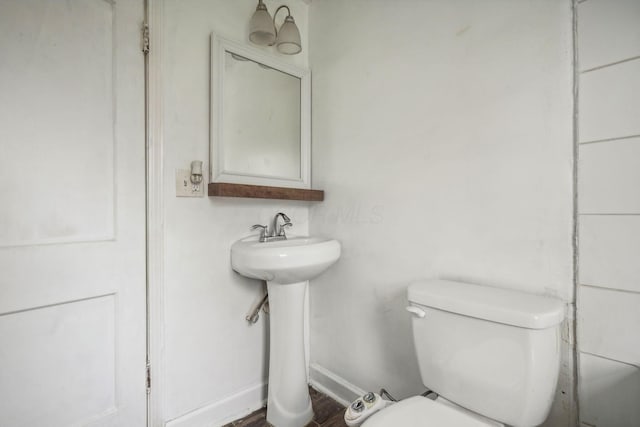 bathroom featuring toilet and hardwood / wood-style floors