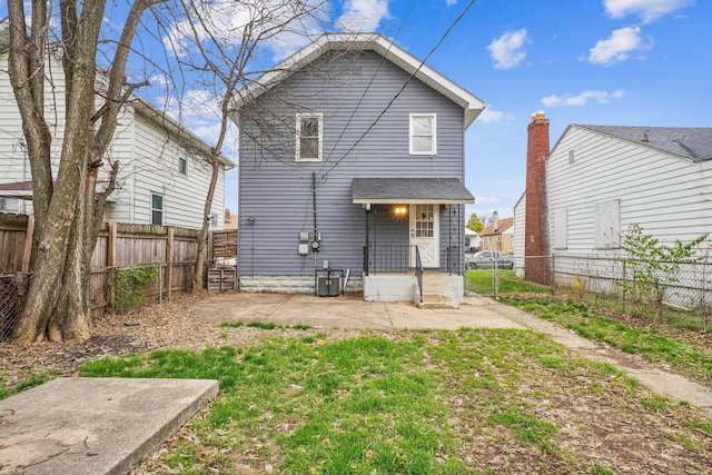 rear view of property with central AC unit